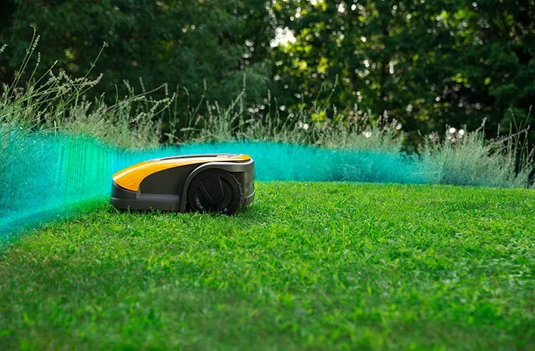 Autonomous robot lawn mower mowing inside the blue virtual perimeter