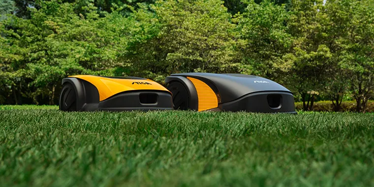 Front view of the new STIGA autonomous robot mowers in the garden